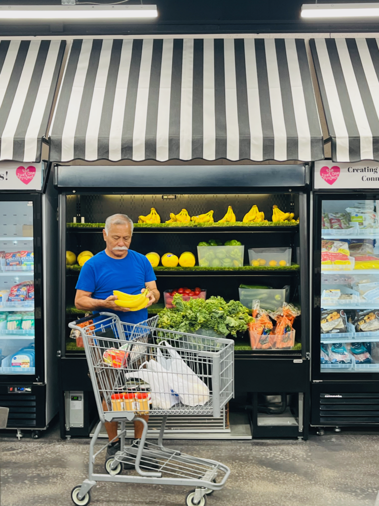 man with shopping cart choosing his produce