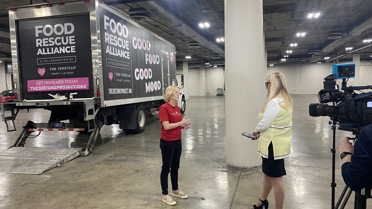 Two women standing in front of a food rescue alliance truck.