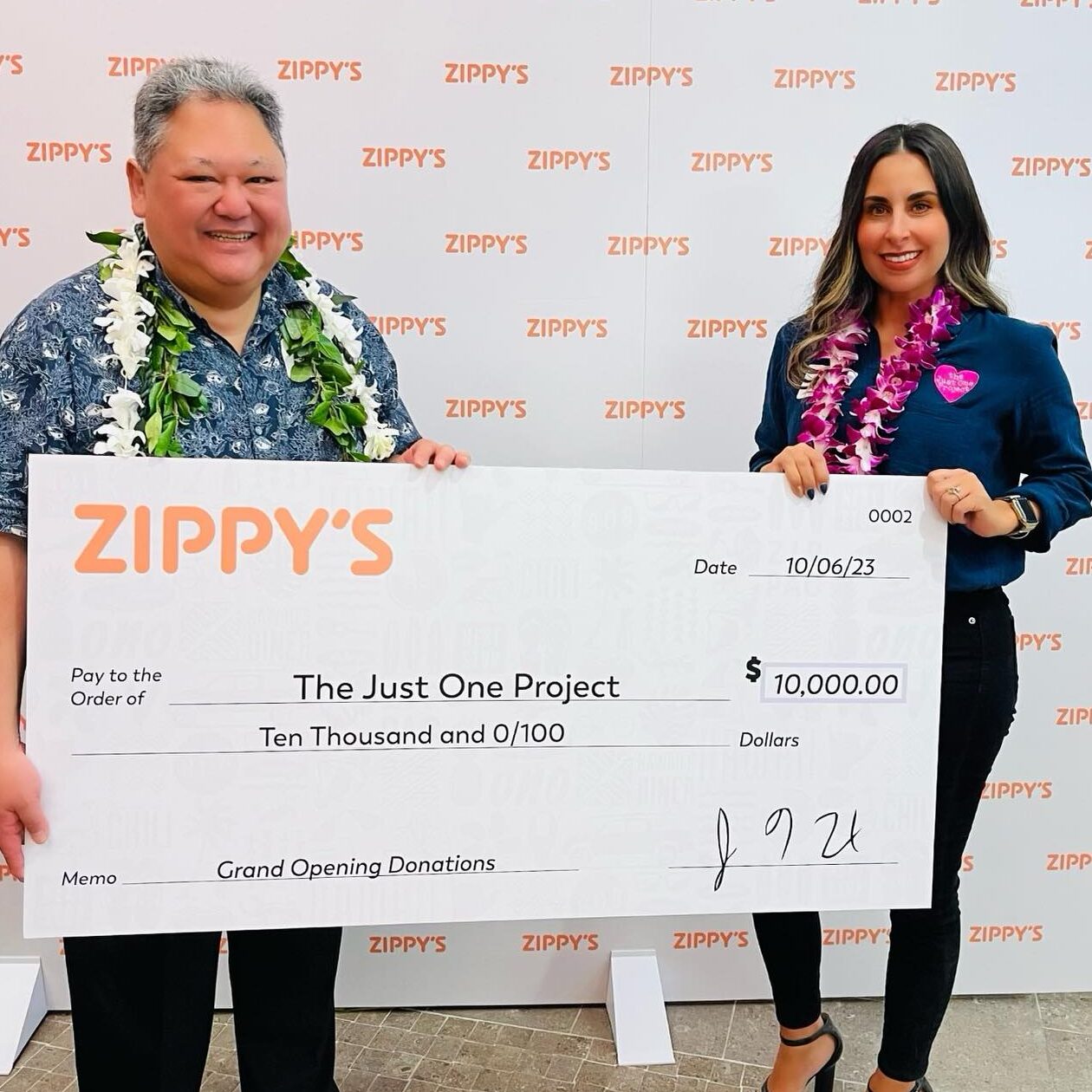 A man and woman holding up a giant check.