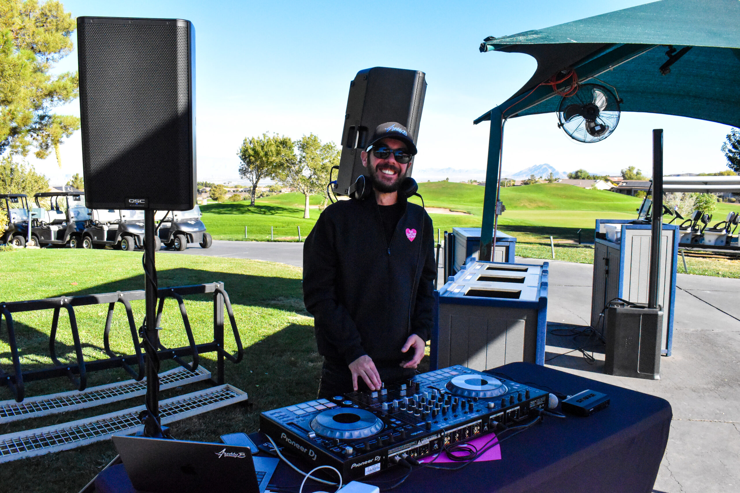 A man standing next to a dj booth.