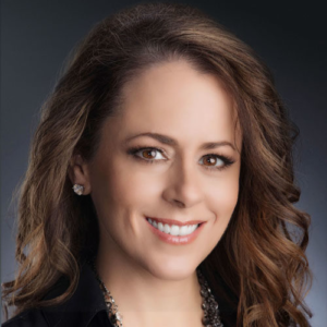 A woman with long brown hair wearing a black shirt.