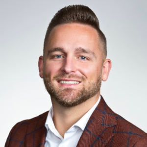 A man with a beard and jacket on.